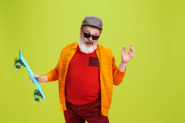 istock Senior hipster man wearing eyeglasses posing on green background. Tech and joyful elderly lifestyle concept 1269810613