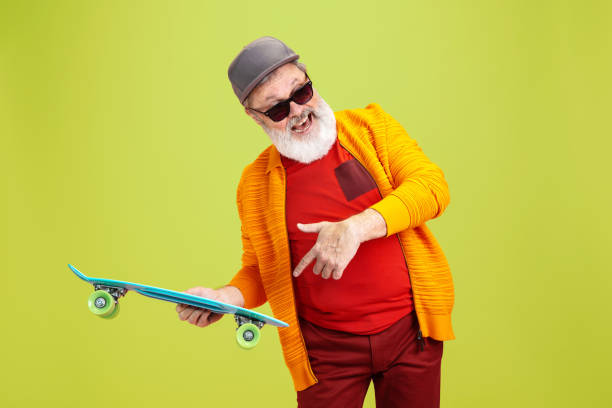 istock Senior hipster man wearing eyeglasses posing on green background. Tech and joyful elderly lifestyle concept 1269810614
