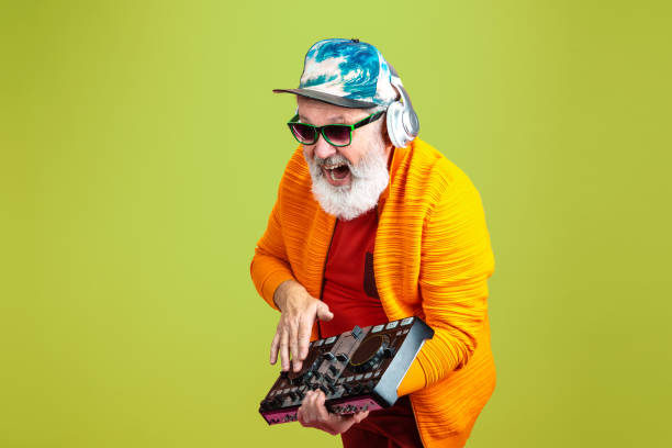 istock Senior hipster man wearing eyeglasses posing on green background. Tech and joyful elderly lifestyle concept 1269810645