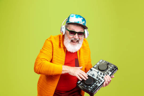 istock Senior hipster man wearing eyeglasses posing on green background. Tech and joyful elderly lifestyle concept 1269810647