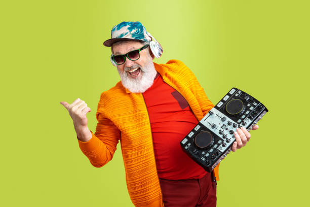 istock Senior hipster man wearing eyeglasses posing on green background. Tech and joyful elderly lifestyle concept 1269810648