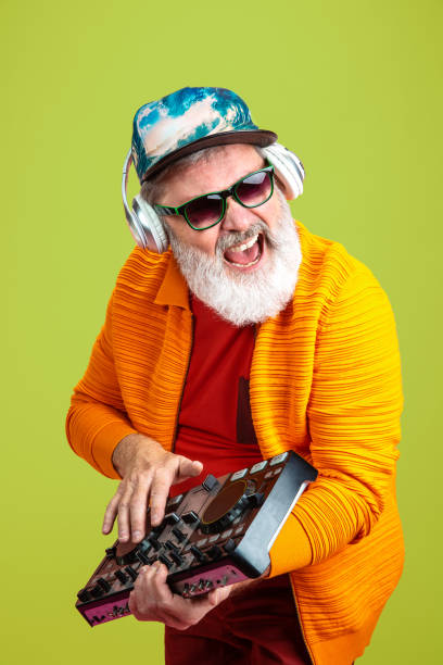 istock Senior hipster man wearing eyeglasses posing on green background. Tech and joyful elderly lifestyle concept 1269810649