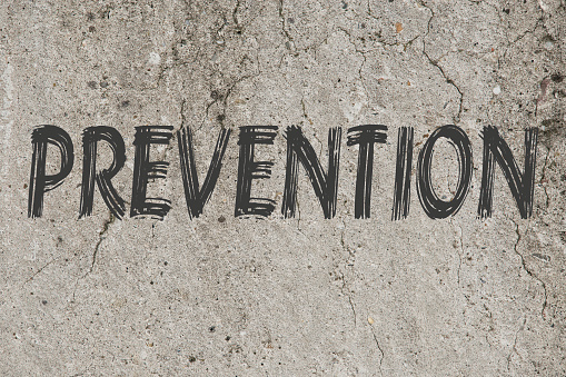 Grey word of text prevention concept on a concrete background