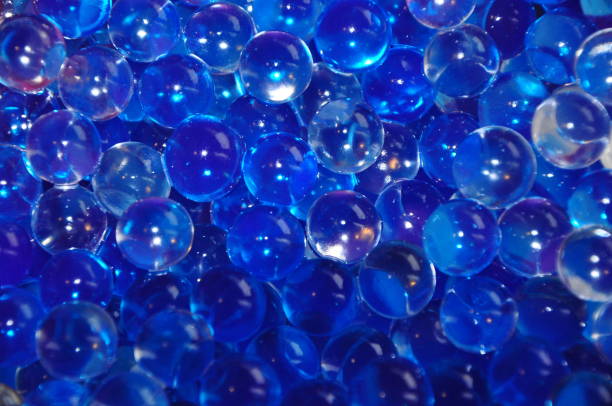 istock Shiny blue water gel bubbles balls background. Dark blue abstract background 1269816240
