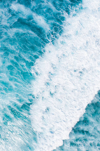 istock Big ocean waves hitting a coral reef. View from above. 1269817255