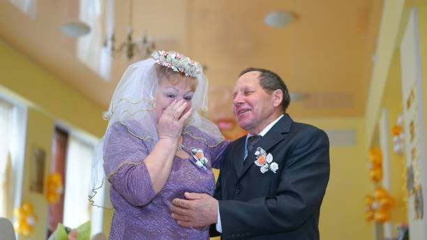 istock old man support your senior wife during golden wedding ceremony 1269823406