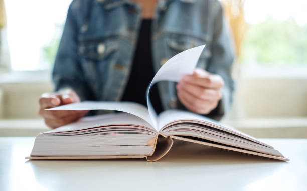 istock a woman sitting and reading book 1269825047