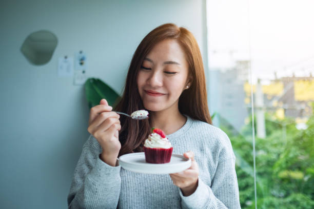 istock A woman enjoyed eating red velvet cup cake 1269825146