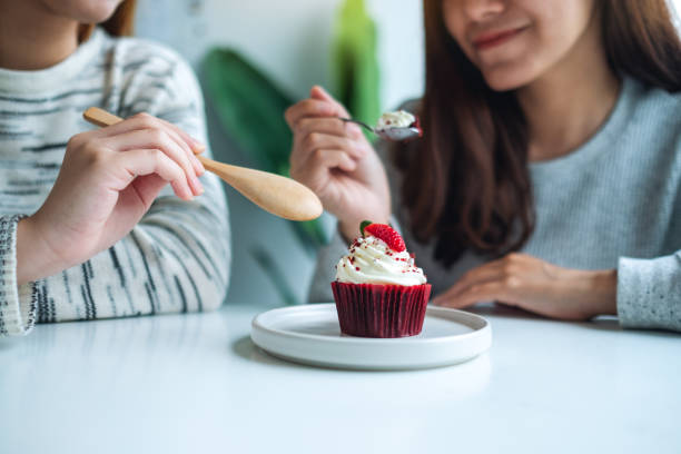 istock Two women enjoyed eating red velvet cup cake 1269825335