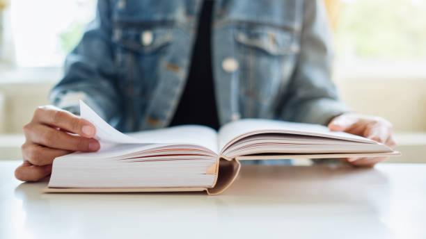 istock a woman sitting and reading book 1269825423