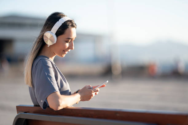 istock Using smart phone and listening to music 1269825542