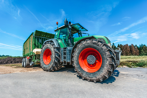Bavaria / Germany - August 20, 2020: Fendt tractor with a loader wagon, working on a biogas plant