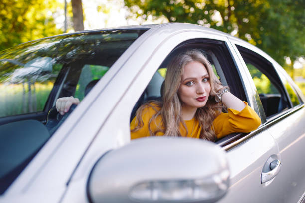 istock A young beautiful girl is driving a car. 1269827823