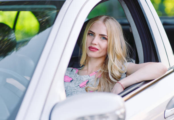 istock A young beautiful girl is driving a car. 1269827846