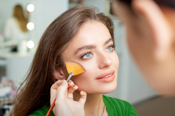 istock Professional make up artist applying powder 1269829648