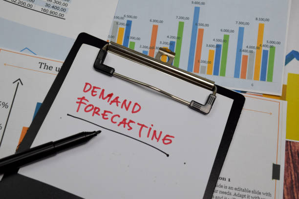 Demand Forecasting write on paperwork isolated on wooden table. stock photo