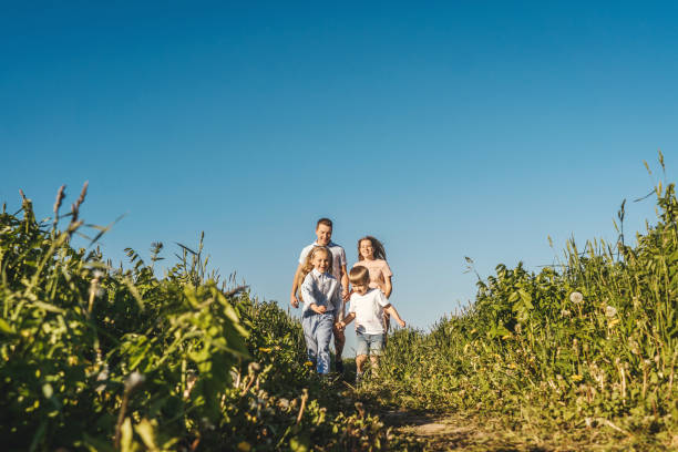 istock Happy family run in field. 1269831096