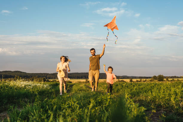 istock Happy family flying a kite 1269831505