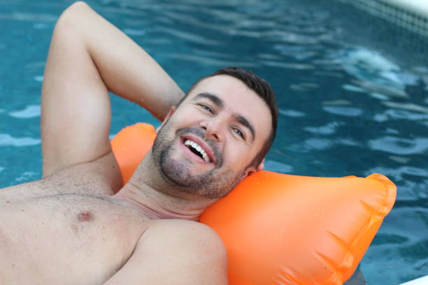 istock Man relaxing in swimming pool 1269832269