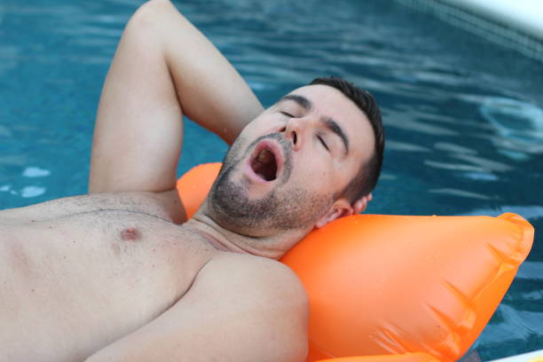 istock Man snoring in swimming pool 1269832295