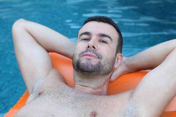 istock Man relaxing in swimming pool 1269832318