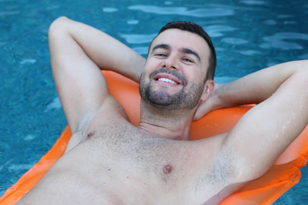 istock Man relaxing in swimming pool 1269832347