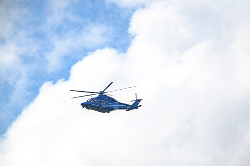 Helicopter Agusta-Westland AW139 PH-PXY of the Dutch Police Aviation Service fitted with camera's for surveillance. The Helicopter is flying in mid air and searching for shoplifters in Kampen, The Netherlands.