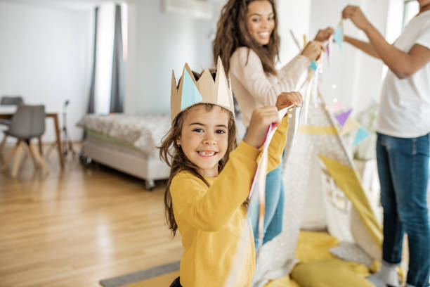 istock Young parents playing with child at home 1269833282