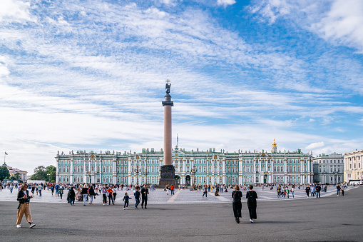 Saint Petersburg, Admiralteisky district - people strolling on Palace Square (Dvortsovaya Ploshchad). The Winter Palace on the background.