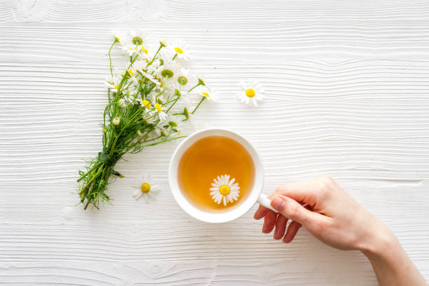 istock Herbal tea with chamomile flowers, top view copy space 1269834619