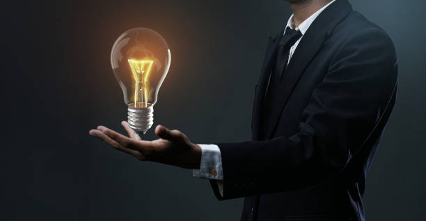 istock Glowing Bulb Floating on Businessman Hand. Stand Out Idea Concept 1269836801