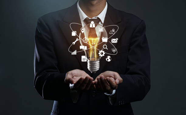 istock Technology  Icons Glowing Bulb Floating on Businessman Hand. Future Stand Out Idea Concept 1269836811