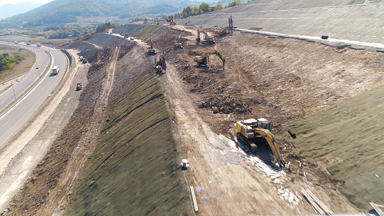 Industrial machinery at work drone shot aerial. Road construction works. Excavators