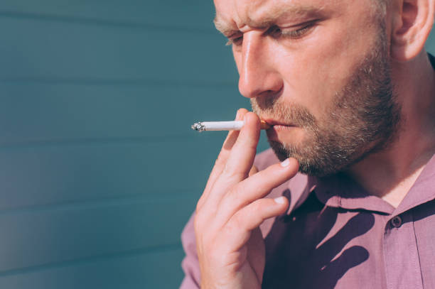 istock A guy with a cigarette in his hands smokes. 1269841727