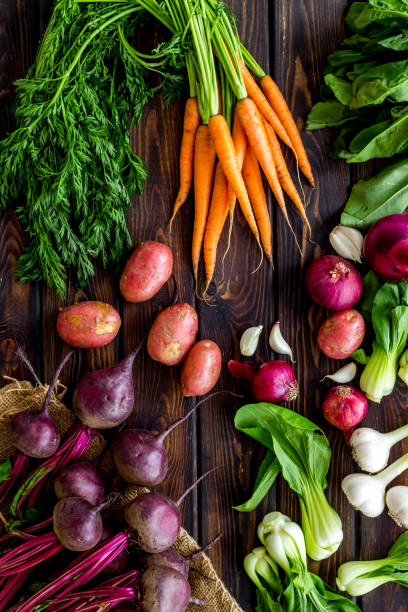 istock Carrot, potato, beet, onion and spinach on wooden background top view 1269843052