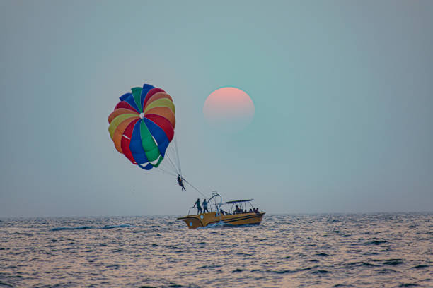 Parasailing at Candolim Beach in Goa - Indian extreme Sport Parasailing at Candolim Beach in Goa - Indian extreme Sport parasailing stock pictures, royalty-free photos & images