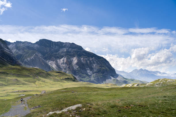 istock woman with a backpack walking on a  far mountain path in the French Pyrenees 1269844642