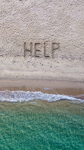 istock Help written on exotic sand beach with tropic blue sea. 1269847524