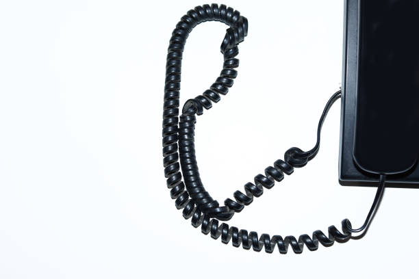 Black old fashioned telephone receiver isolated on a white backgrounds