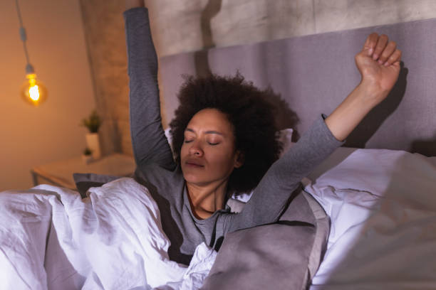 istock Woman stretching in bed after waking up 1269850744