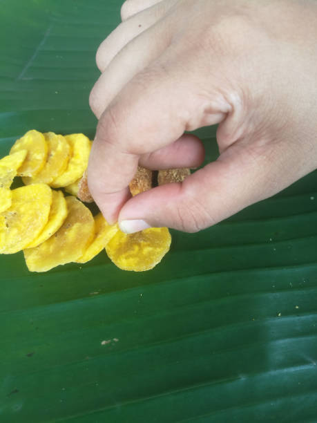 istock Taking starter fried banana chips from a banana leaf for onam sadhya.T 1269851610