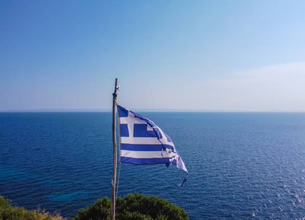 istock Greek flag and sea at the back 1269851738