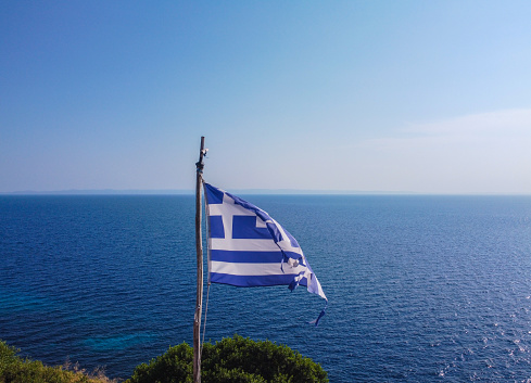 Greek flag and sea at the back