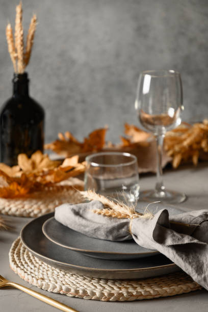 istock Autumn table setting with dry yellow oak leaves, fall decoration on grey table. Flat lay, top view. Thankisgiving day 1269852097