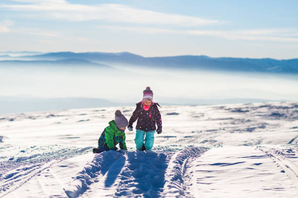 istock Happy kids enjoying winter snow 1269852770