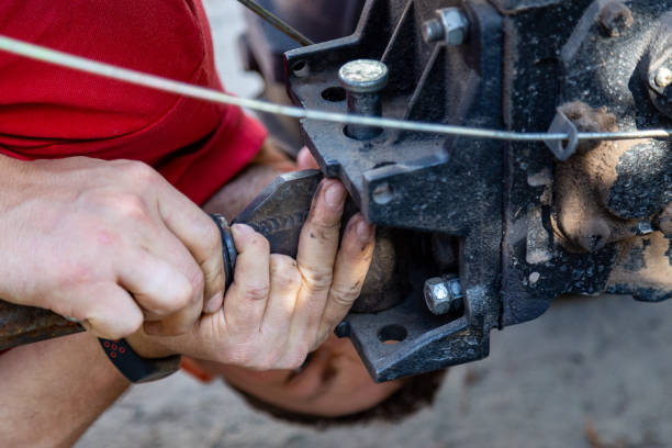 istock Person attaching a plow attachment to a Two-wheel tractor also called motor block or walking tractor. 1269855106