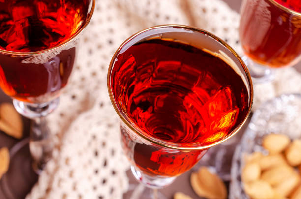 Traditional brown almond liquid in a glass on a stone background. Selective focus.