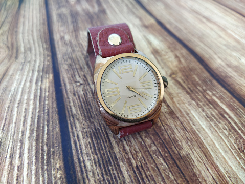 Mechanical wrist watch on wooden table background