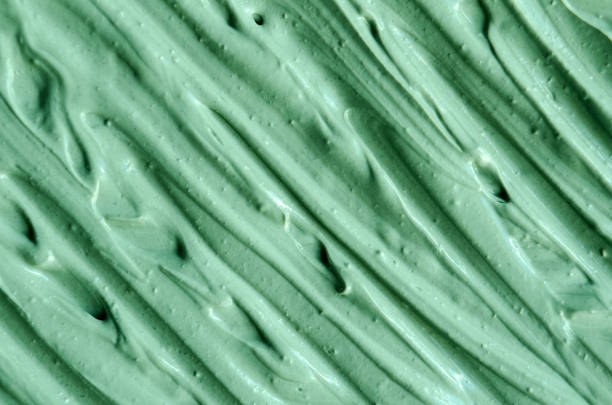 istock Green cosmetic clay (kelp facial mask, face cream, spirulina body wrap) texture close up, selective focus. Abstract background with brush strokes. 1269858160