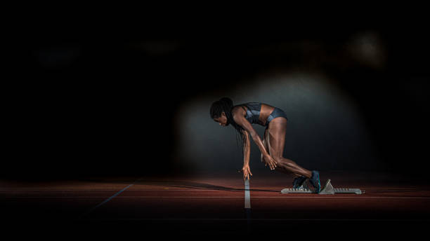 istock Female African-American sprinter starting at the starting line 1269858247